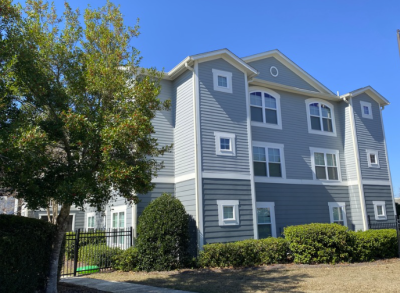 An outside view of a Freedom's Landing building with three floors of apartments included porches