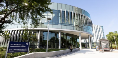 Outside view of the Academic and Residential Complex with sign visible in the left hand corner
