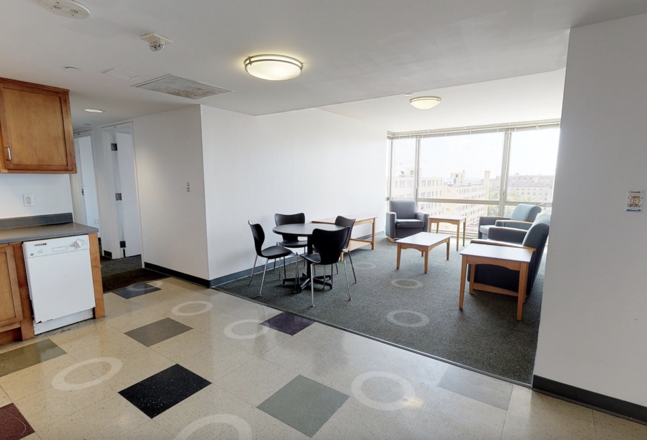Wide angle shot of kitchen, living room, and hallway.