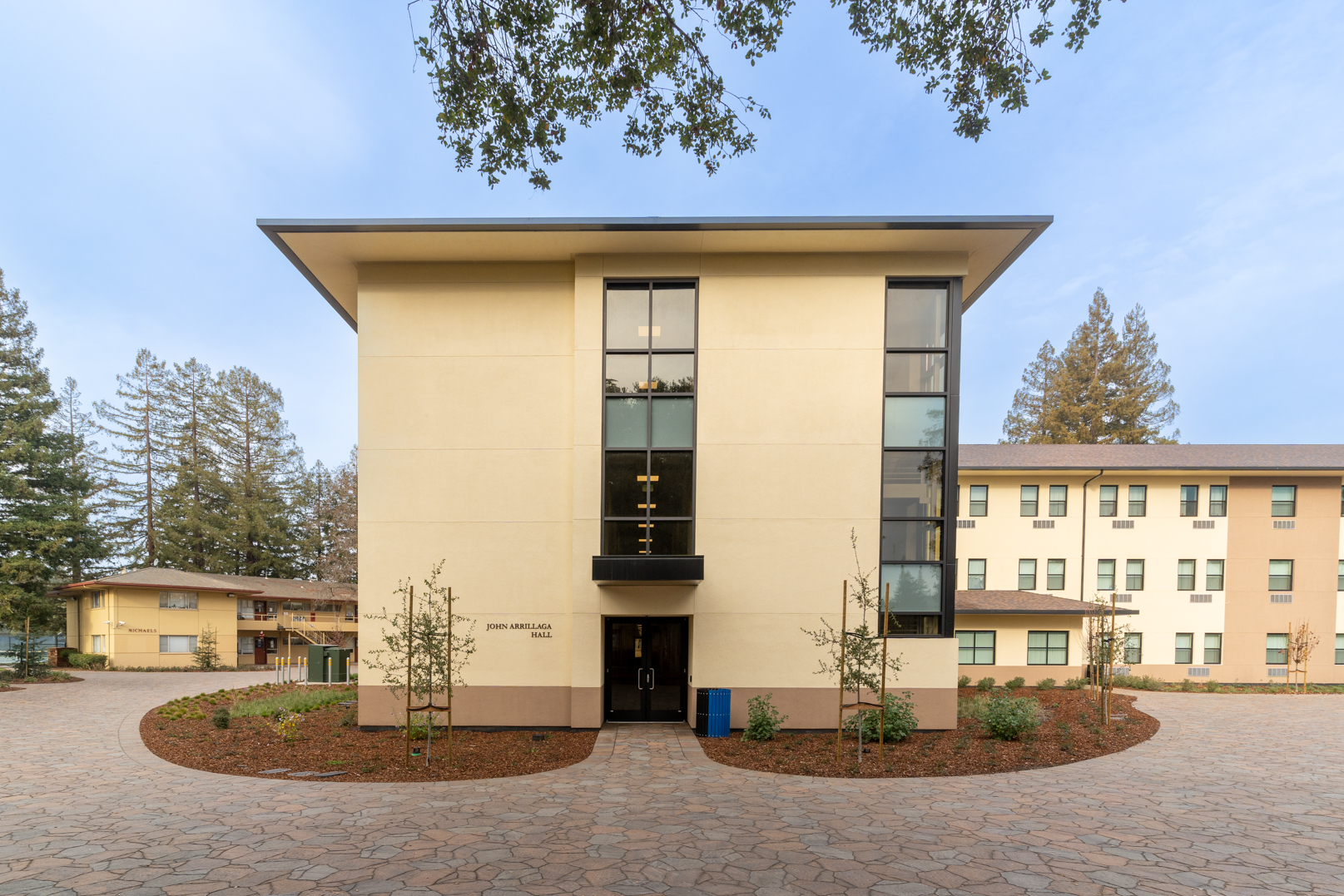 An exterior picture taken looking directly at the entrance of the John Arrillaga residence hall at Menlo College 