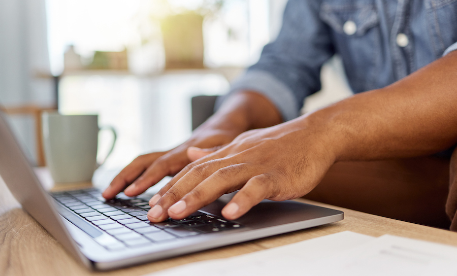 Man typing on a laptop computer