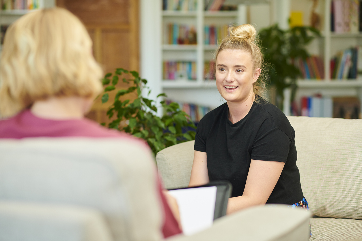 Career advisor sitting with a college student in an office