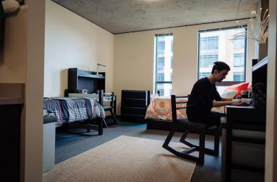 Cornish Commons dorm room with a student sitting at a desk working