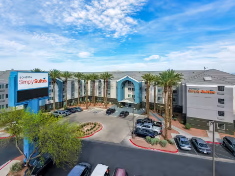 Another drone shot of the exterior of the Sonesta Suites with a clear blue sky 
