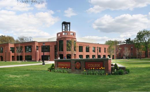 A wide angle shot of the student union in the background with the focus on the Springfield College sign