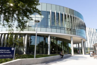Outside view of the Academic and Residential Complex with sign visible in the left hand corner