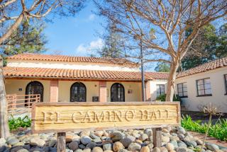 Picture of the El Camino Hall sign out front of an exterior shot of the building